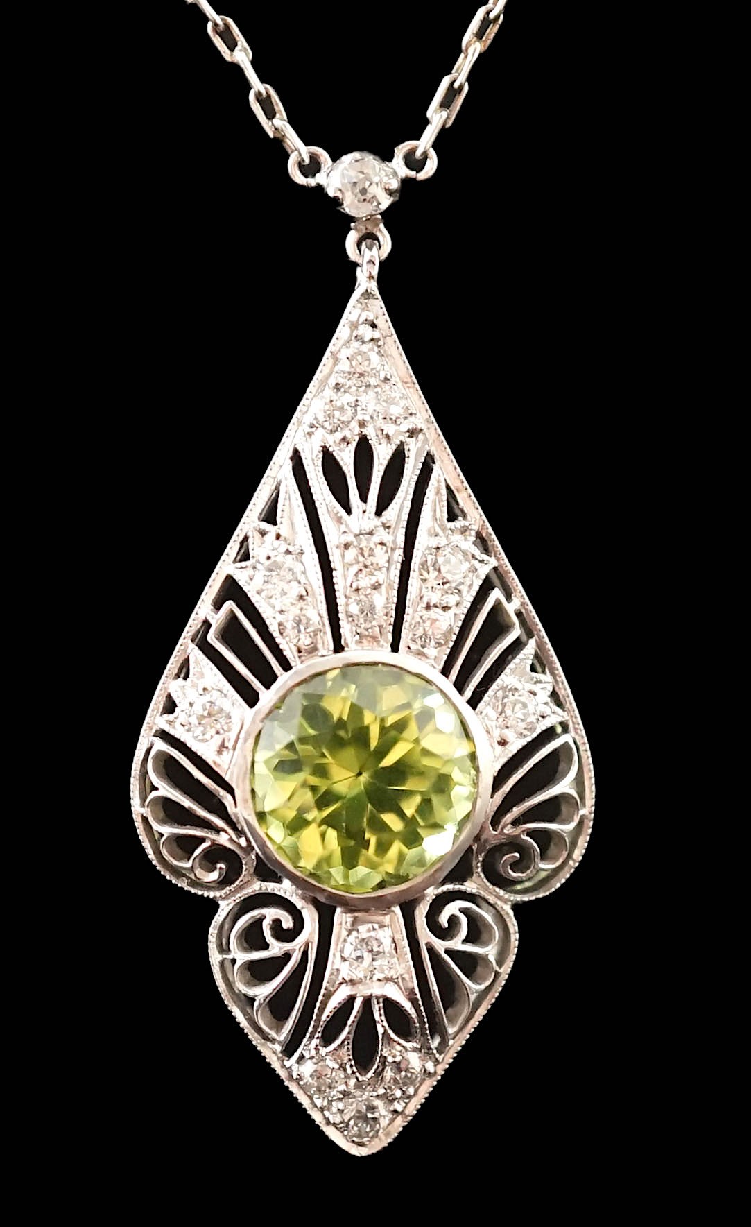 A 1920's pierced platinum, peridot and millegrain set diamond cluster set pendant necklace